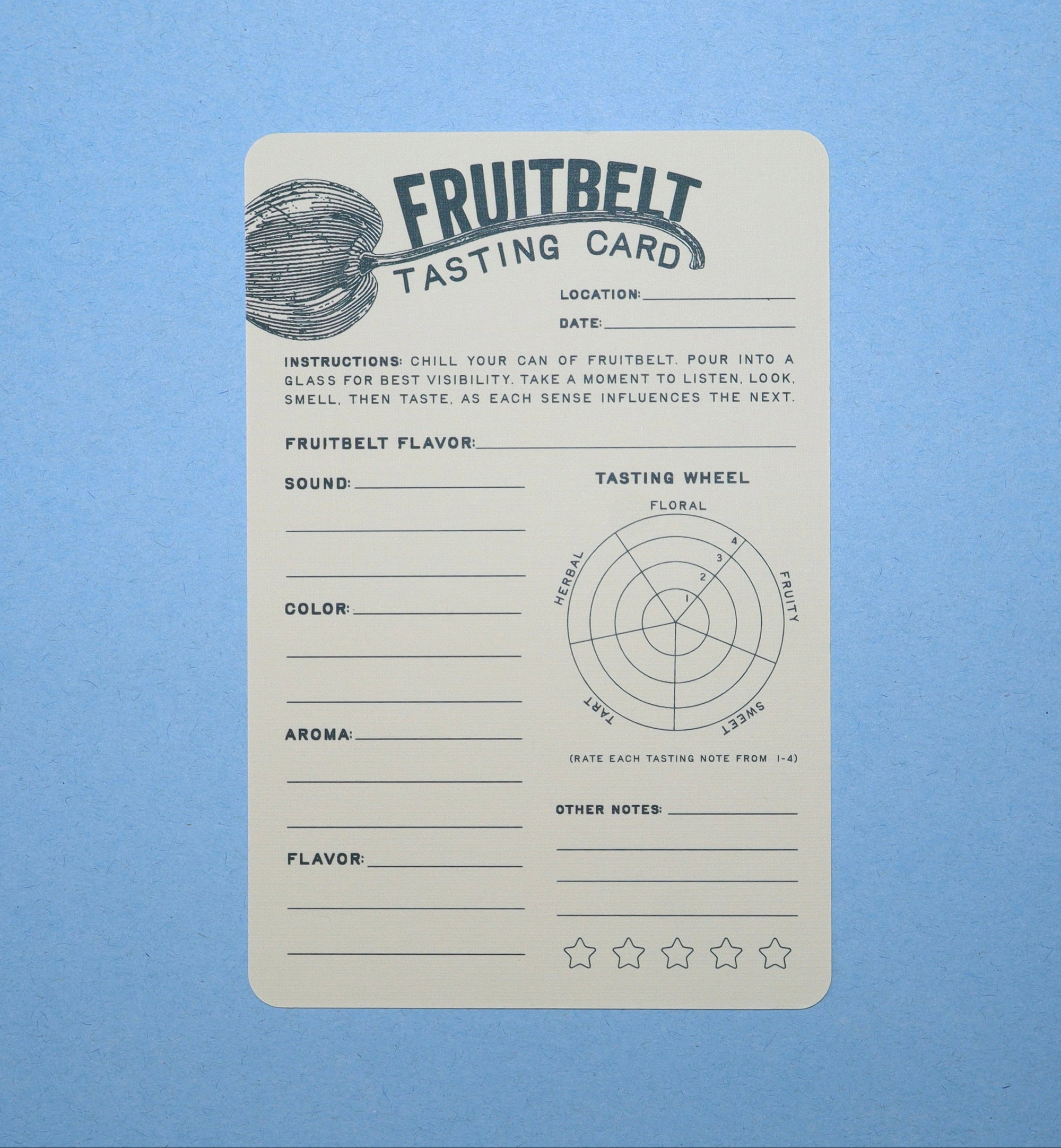 A fruitbelt Tasting Card with printed guidelines and a tasting wheel diagram, shown on a solid light blue background.